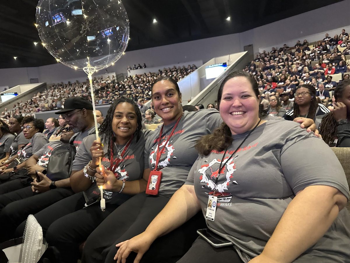 Ms. Allen, Coach Chase and Ms. Holcomb show off their balloon in recognition for their North American Robot Project at 2023 Humble ISD Convocation.