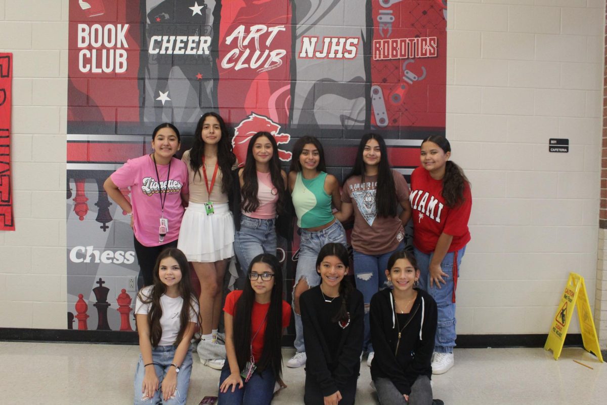 Ten seventh grade girls with Hispanic Heritage come together to pose for a picture.